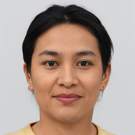Joyful latino young-adult female with short  brown hair and brown eyes