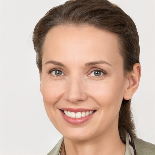 Joyful white young-adult female with long  brown hair and grey eyes