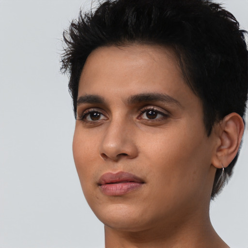 Joyful latino young-adult female with short  black hair and brown eyes