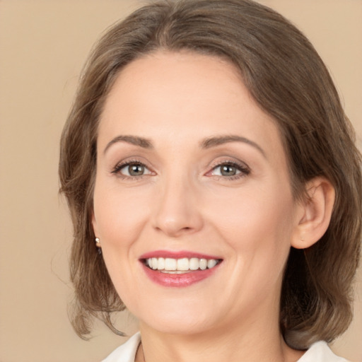 Joyful white adult female with medium  brown hair and brown eyes