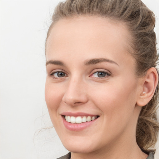 Joyful white young-adult female with medium  brown hair and blue eyes