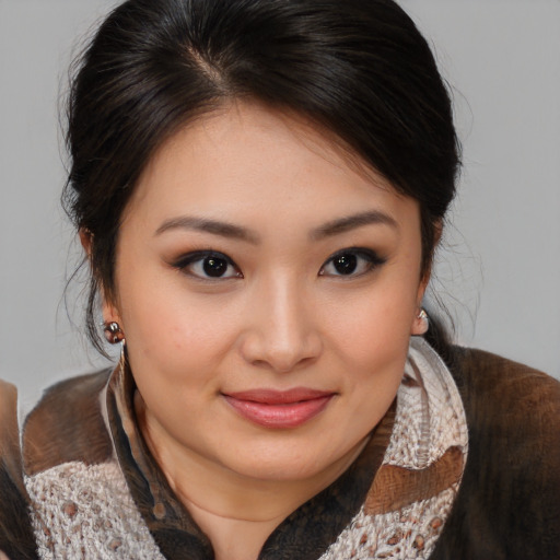 Joyful asian young-adult female with medium  brown hair and brown eyes