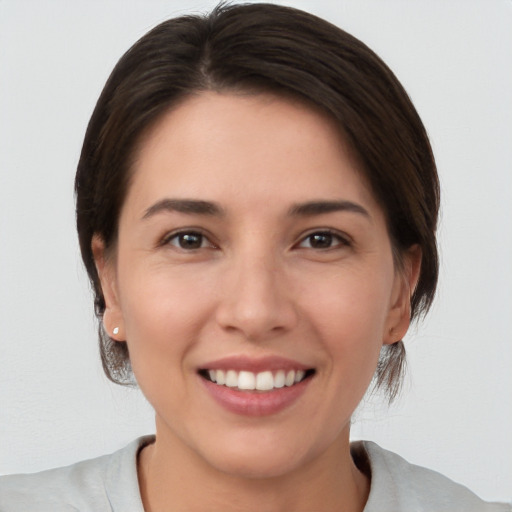 Joyful white young-adult female with medium  brown hair and brown eyes