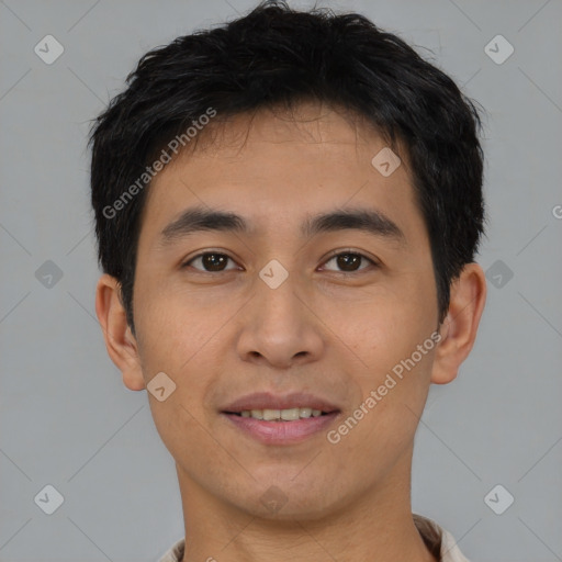 Joyful asian young-adult male with short  brown hair and brown eyes