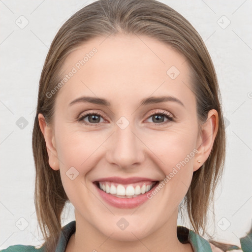 Joyful white young-adult female with medium  brown hair and grey eyes