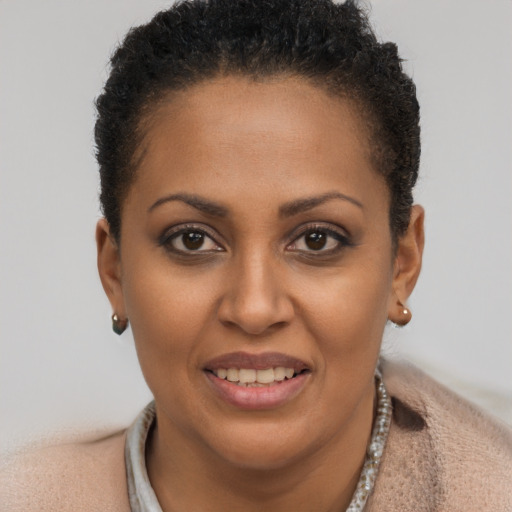 Joyful black young-adult female with short  brown hair and brown eyes