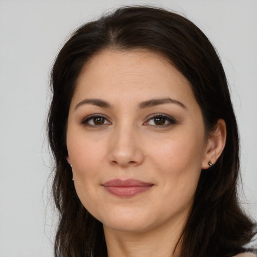 Joyful white young-adult female with long  brown hair and brown eyes