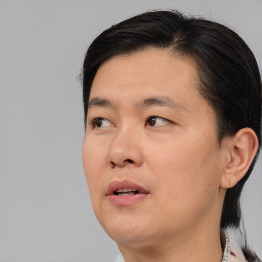 Neutral asian adult male with medium  brown hair and brown eyes