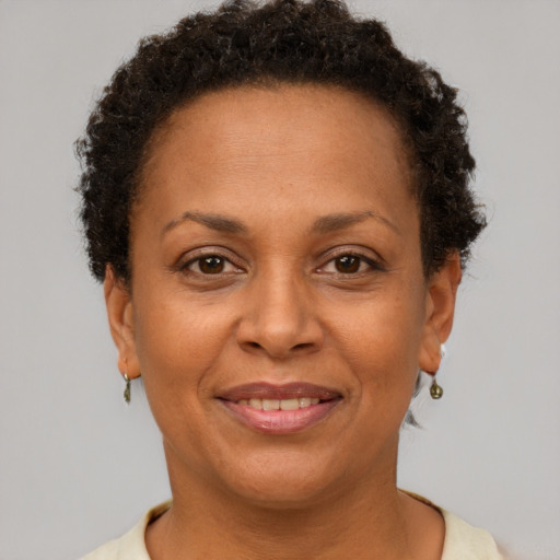 Joyful black adult female with short  brown hair and brown eyes