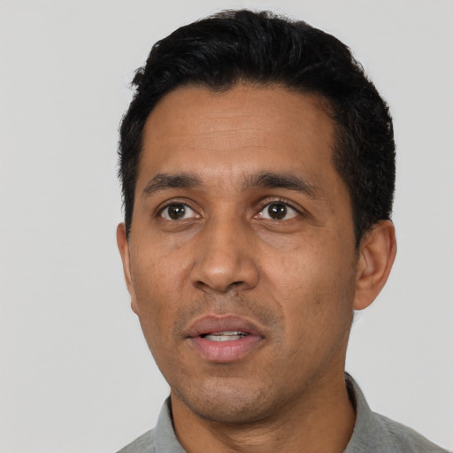 Neutral latino adult male with short  black hair and brown eyes