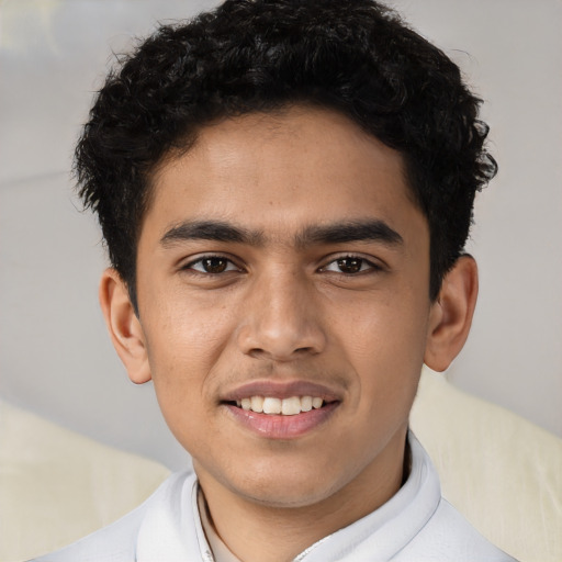 Joyful latino young-adult male with short  brown hair and brown eyes