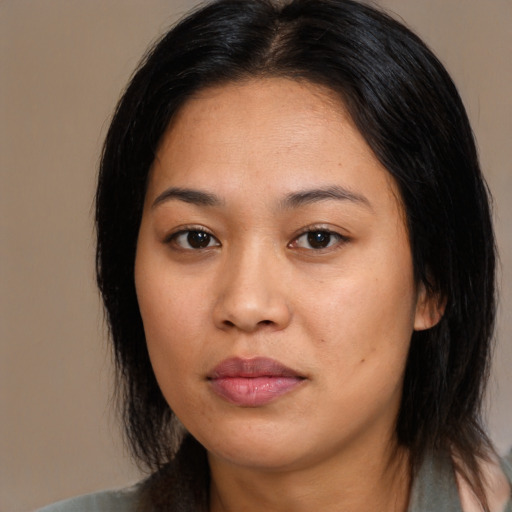 Joyful asian young-adult female with long  black hair and brown eyes
