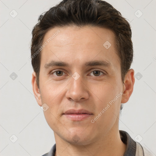 Joyful white adult male with short  brown hair and brown eyes