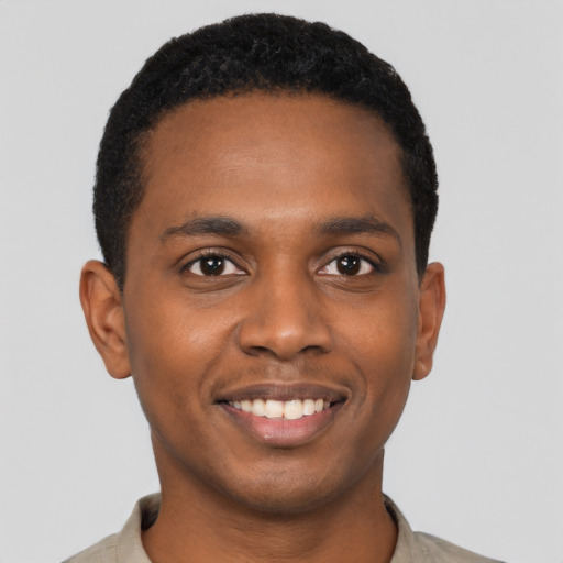 Joyful black young-adult male with short  black hair and brown eyes