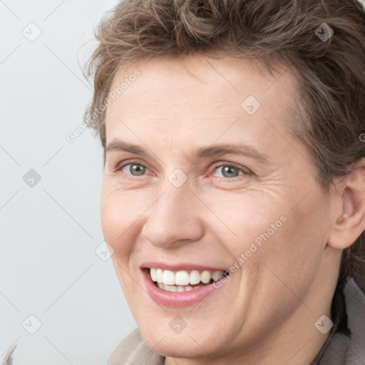 Joyful white adult male with short  brown hair and grey eyes