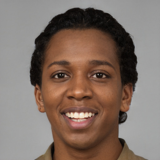 Joyful black young-adult female with short  black hair and brown eyes