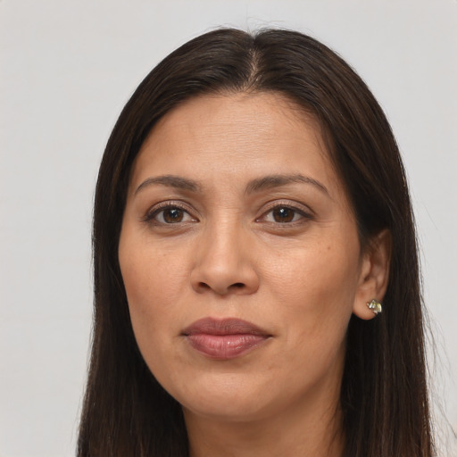 Joyful white adult female with long  brown hair and brown eyes