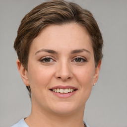 Joyful white young-adult female with short  brown hair and grey eyes