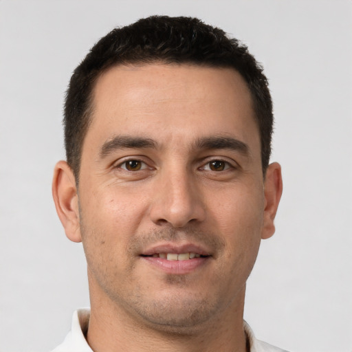 Joyful white young-adult male with short  brown hair and brown eyes