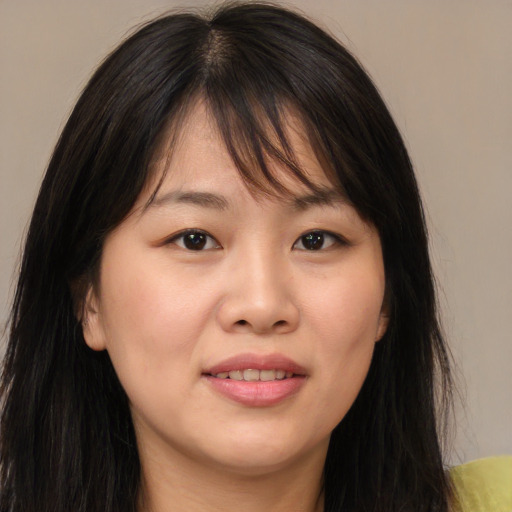 Joyful asian young-adult female with long  brown hair and brown eyes