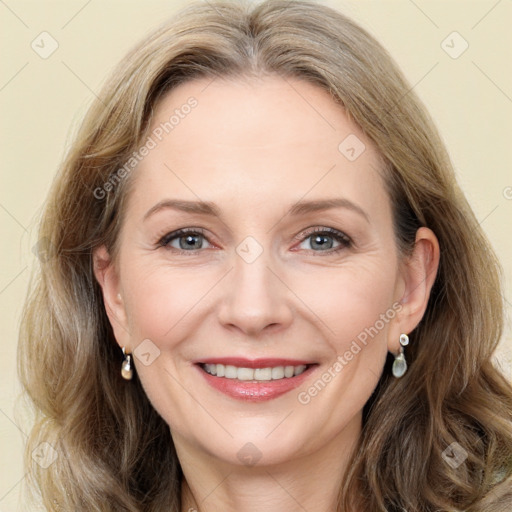 Joyful white adult female with long  brown hair and grey eyes