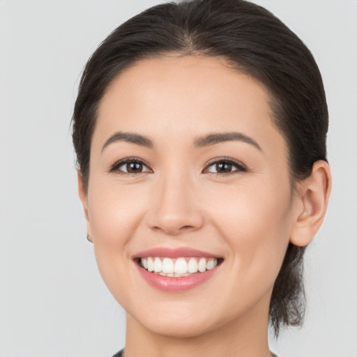 Joyful white young-adult female with medium  brown hair and brown eyes