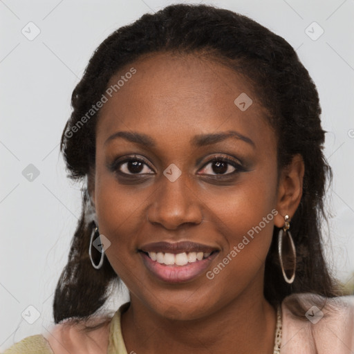 Joyful black young-adult female with long  brown hair and brown eyes