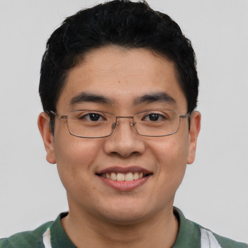 Joyful asian young-adult male with short  black hair and brown eyes