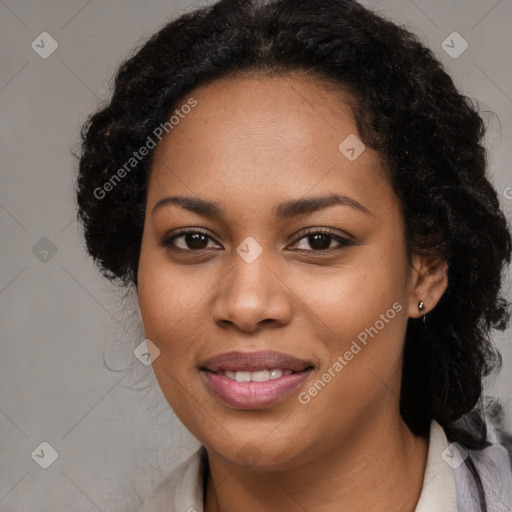 Joyful black young-adult female with long  brown hair and brown eyes