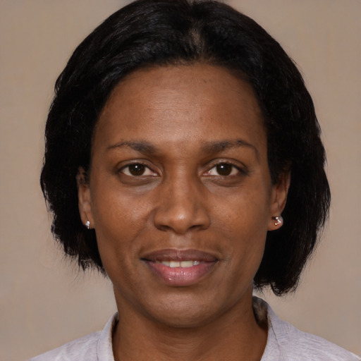 Joyful black adult female with medium  black hair and brown eyes