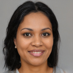 Joyful black young-adult female with medium  brown hair and brown eyes