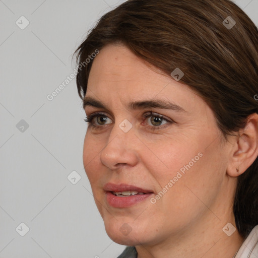 Joyful white adult female with medium  brown hair and brown eyes