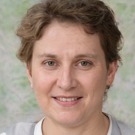 Joyful white adult female with short  brown hair and grey eyes