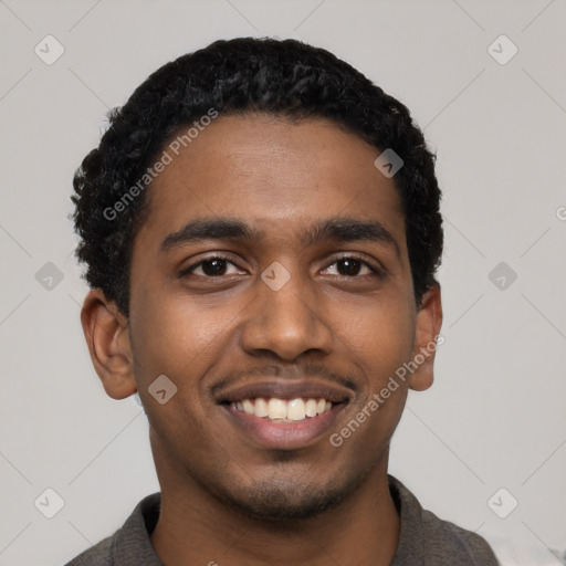 Joyful black young-adult male with short  black hair and brown eyes