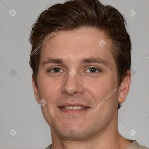 Joyful white adult male with short  brown hair and grey eyes