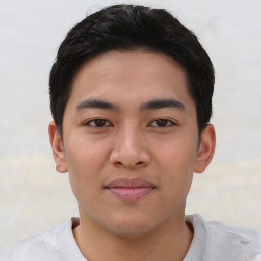 Joyful asian young-adult male with short  brown hair and brown eyes
