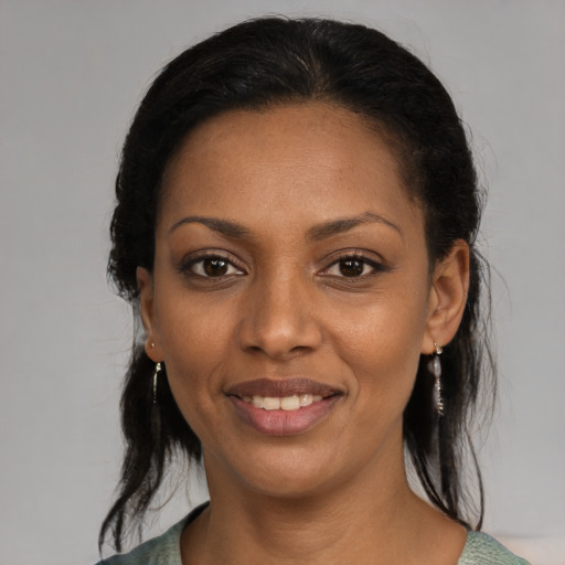 Joyful black young-adult female with medium  black hair and brown eyes