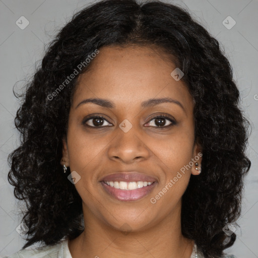 Joyful black young-adult female with long  brown hair and brown eyes