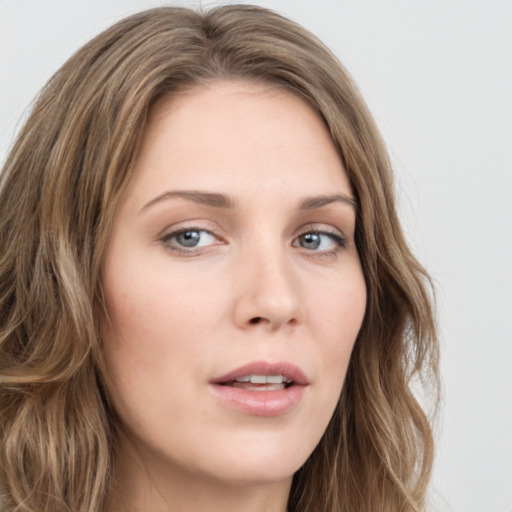 Neutral white young-adult female with long  brown hair and green eyes