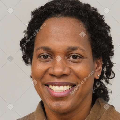 Joyful black adult female with short  brown hair and brown eyes