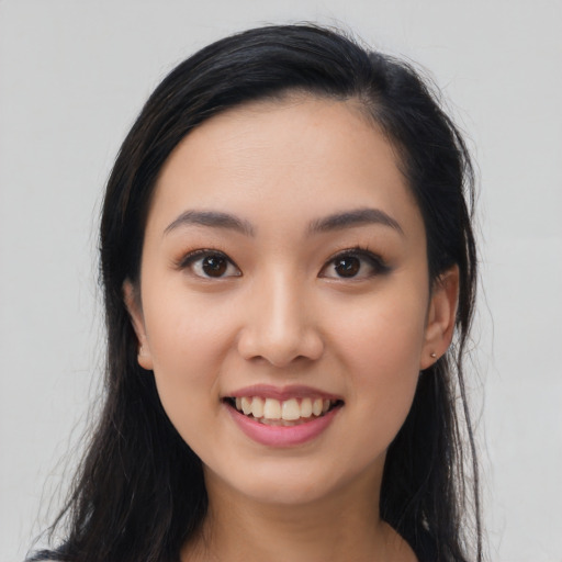 Joyful latino young-adult female with long  black hair and brown eyes