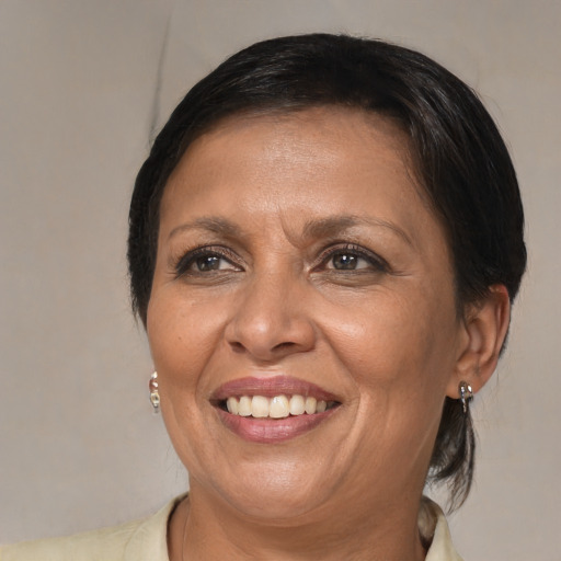 Joyful black adult female with medium  brown hair and brown eyes
