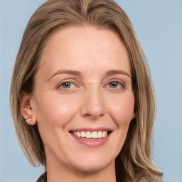 Joyful white adult female with long  brown hair and blue eyes