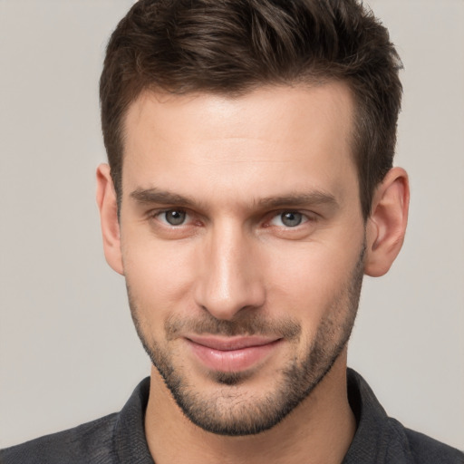 Joyful white young-adult male with short  brown hair and brown eyes