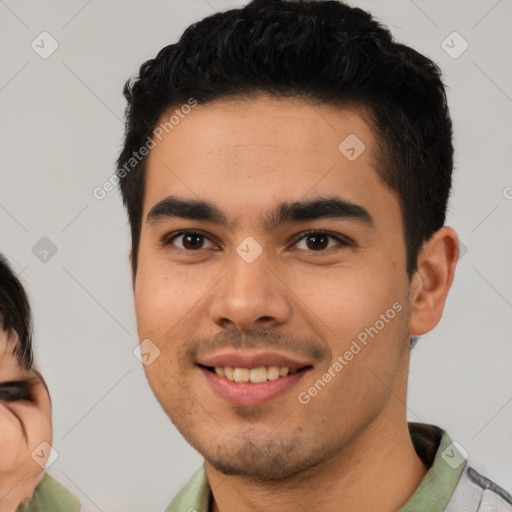 Joyful latino young-adult male with short  brown hair and brown eyes