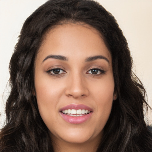 Joyful white young-adult female with long  black hair and brown eyes