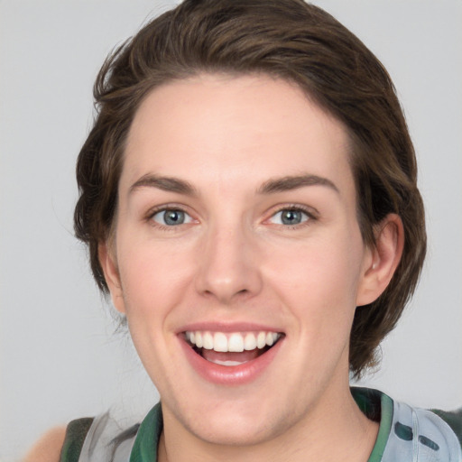 Joyful white young-adult female with medium  brown hair and green eyes