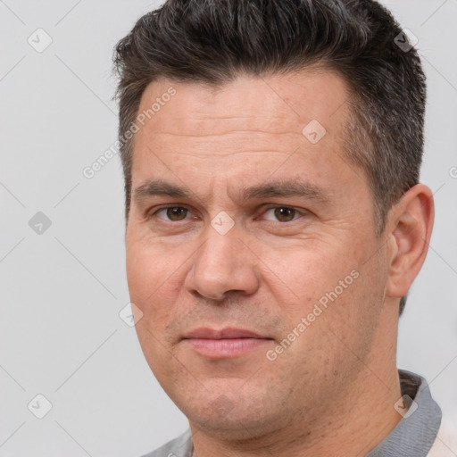 Joyful white adult male with short  brown hair and brown eyes