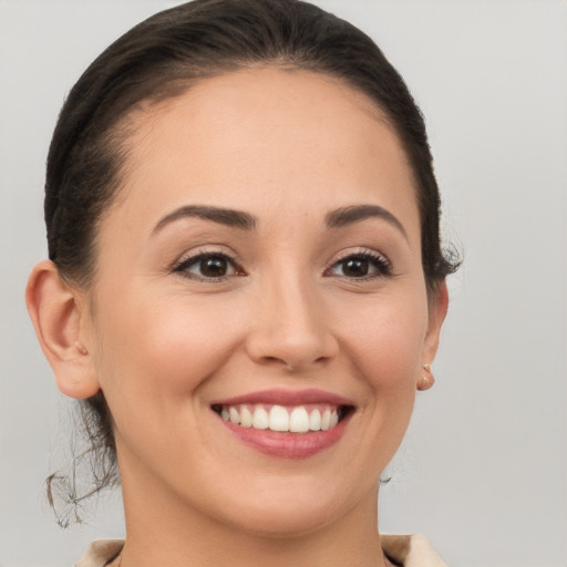 Joyful white young-adult female with short  brown hair and brown eyes