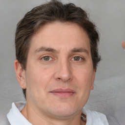 Joyful white adult male with short  brown hair and grey eyes